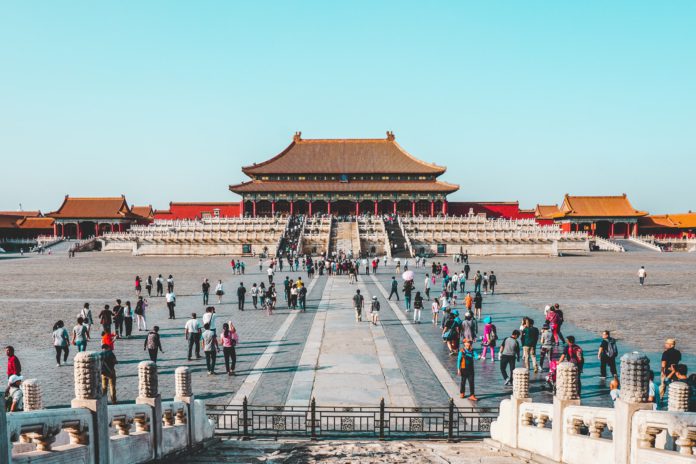Chinese building with people around it