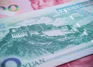 CNBC: China Closes Hundreds of Banks to Strengthen Its Financial System Close-up of a Chinese yuan banknote showing a historic fortress/Great Wall-style illustration and security patterns
