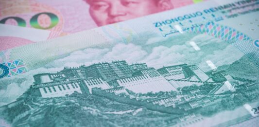 Close-up of a Chinese yuan banknote showing a historic fortress/Great Wall-style illustration and security patterns