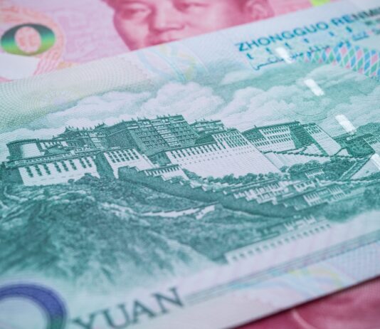 CNBC: China Closes Hundreds of Banks to Strengthen Its Financial System Close-up of a Chinese yuan banknote showing a historic fortress/Great Wall-style illustration and security patterns