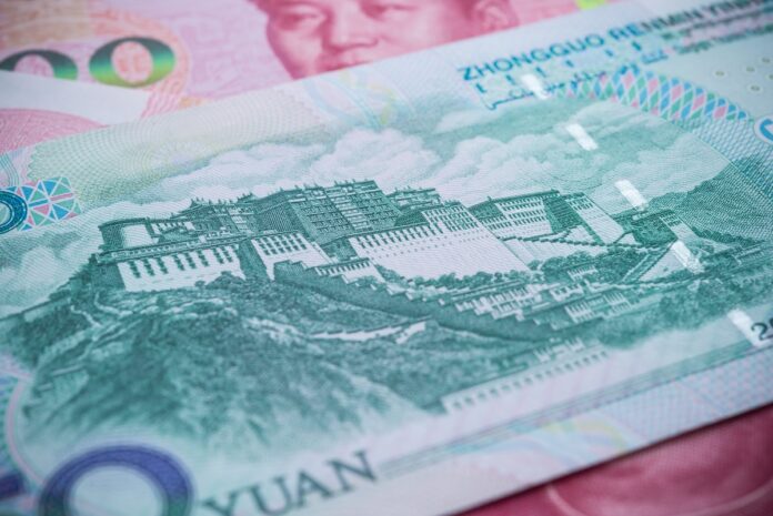 Close-up of a Chinese yuan banknote showing a historic fortress/Great Wall-style illustration and security patterns